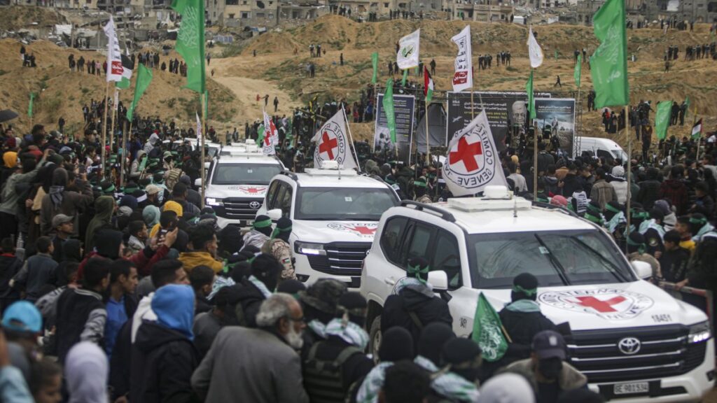 Red Cross vehicles arrive to collect the coffins containing the bodies of four Israeli hostages, including a mother and her two children, who had long been feared dead, to be handed over Hamas in Khan Younis, southern Gaza Strip, Thursday, Feb. 20, 2025. (AP Photo)