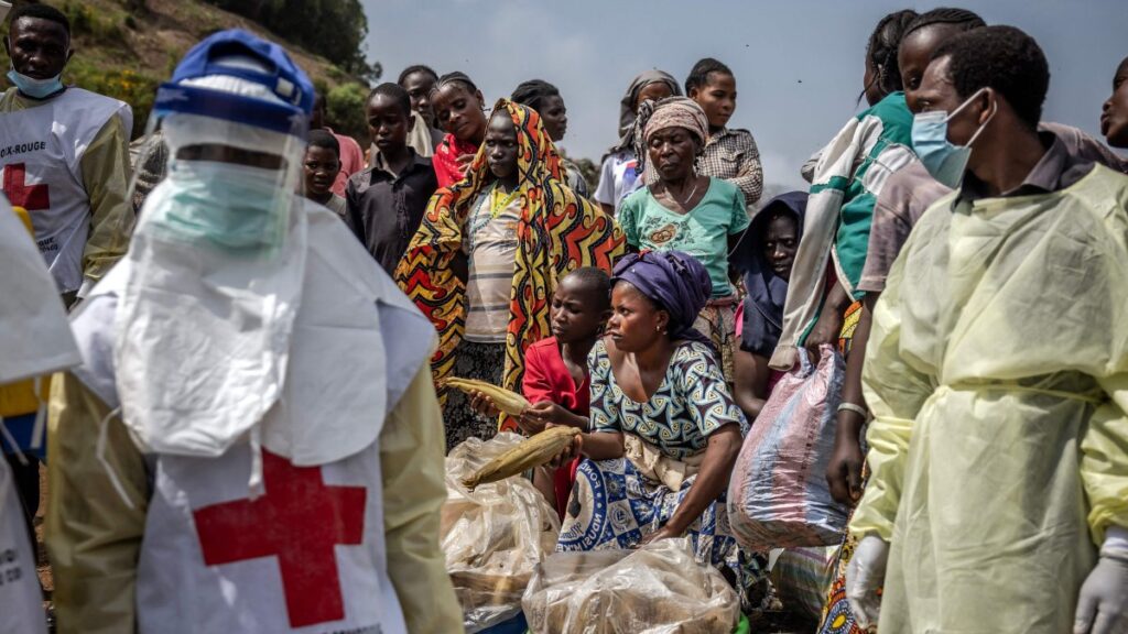 Women sell maize as members of the Congolese Red Cross arrive to bury M23 rebels victims at the Musigiko cemetery, Bukavu, DRC, Feb. 20, 2025. (AFP Photo)