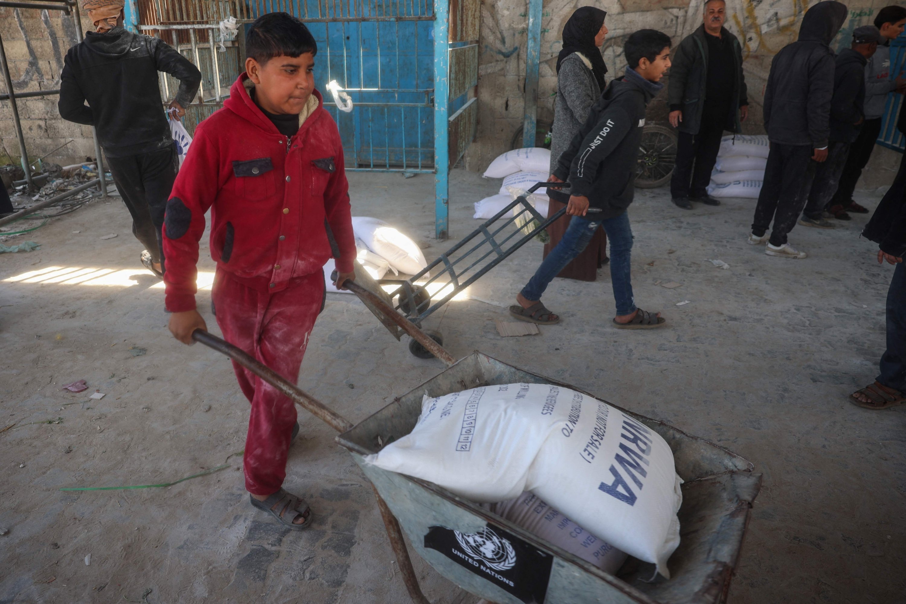 372964 Palestinians receive food aid from a UNRWA distribution center at the Nuseirat refugee camp, Gaza Strip, Palestine, March 3, 2025. (AFP Photo)