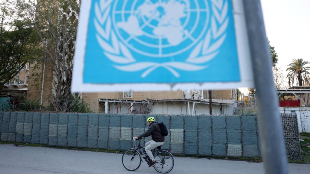 A man crosses the Ledra Palace checkpoint on his bicycle in the U.N. buffer zone, Nicosia, Cyprus, Dec. 5, 2024. (Reuters Photo)