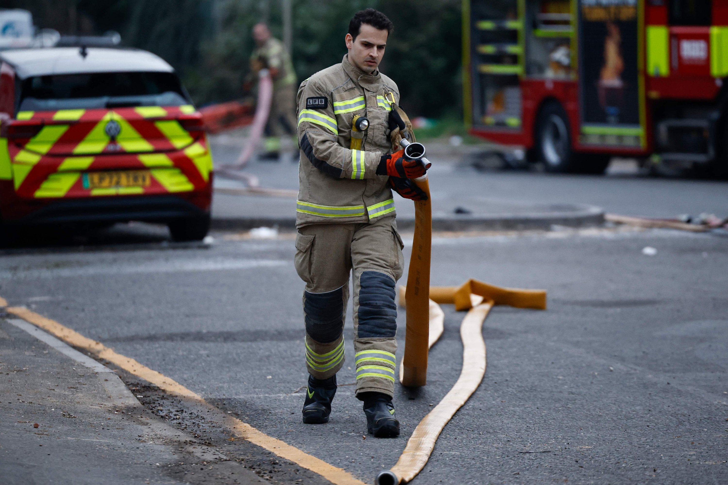 373994 A firefighter helps put out a fire that broke out at a substation supplying power to Heathrow Airport, Hayes, London, U.K., March 21, 2025. (AFP Photo)