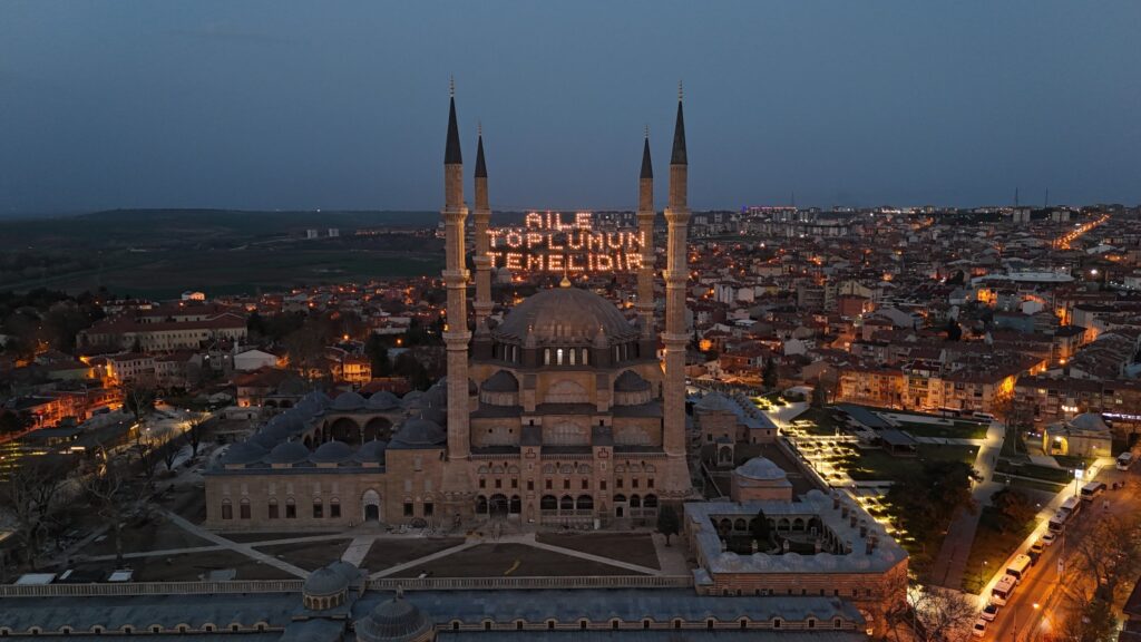 The illuminated mahya reading "Family is the foundation of society" hangs the minarets of Selimiye Mosque, Edirne, Türkiye, March 17, 2025. (IHA Photo)