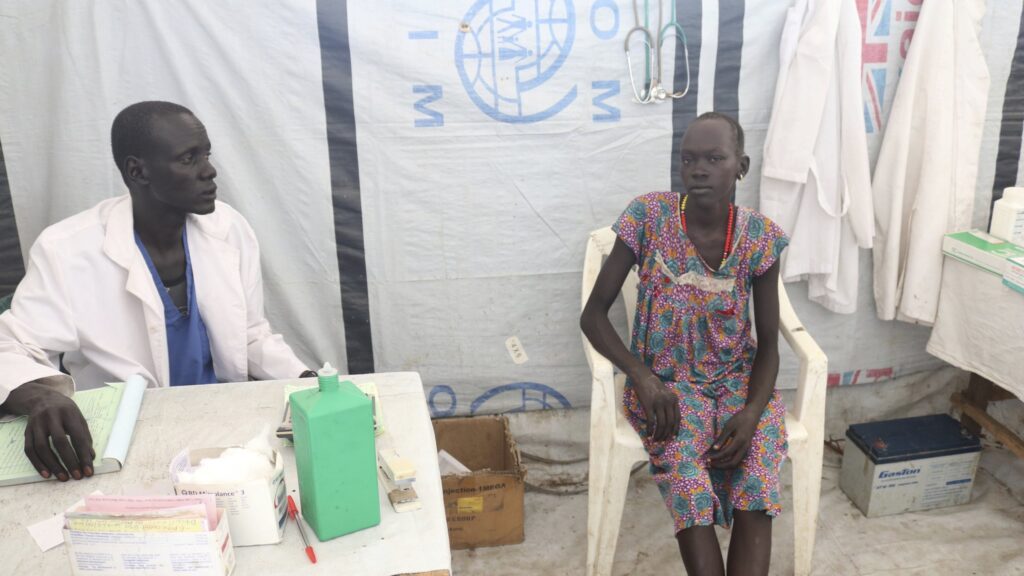 A lab technician James Khor, treats a patient at his private clinic, which is right across from the cholera center set up by Doctors Without Borders, Pieri, South Sudan, June 27, 2017. (AP Photo)