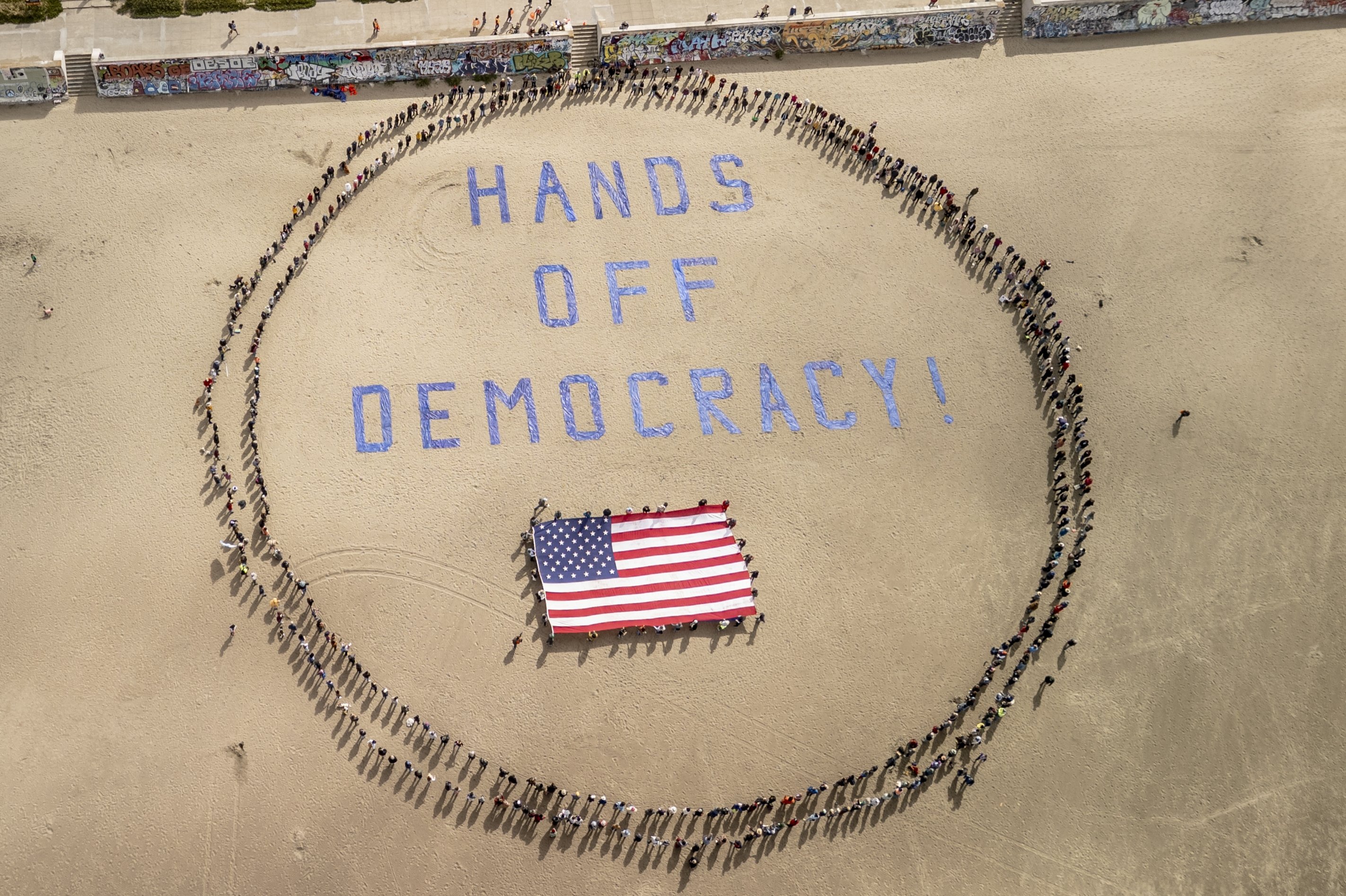 376230 Protesters form a human banner on Ocean Beach during a protest against President Donald Trump, in San Francisco, California, U.S., April 5, 2025. (AP Photo)