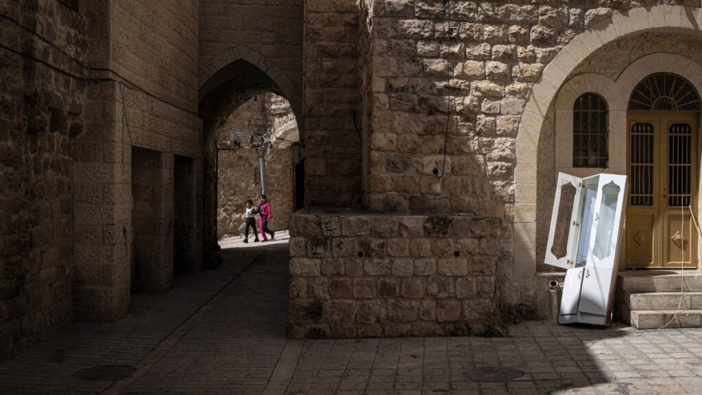 Palestinian girls walk near uninhabited houses in old Hebron in the occupied West Bank, Palestine, April 3, 2025. (AFP Photo)