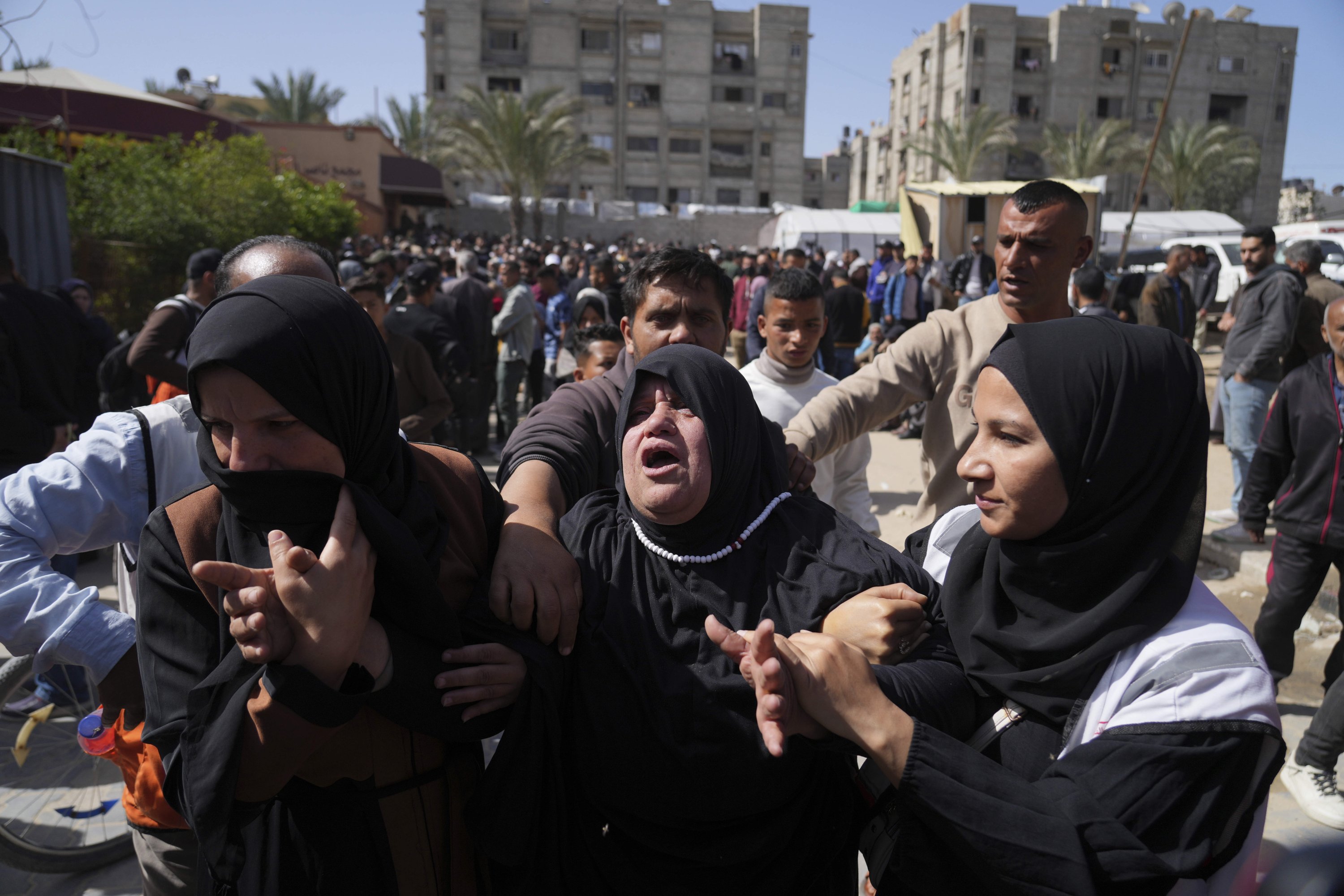 376325 Mourners react during the funeral of 8 Red Crescent emergency responders, recovered in Rafah a week after an Israeli attack, in Deir al-Balah, Gaza Strip, Palestine, March 31, 2025. (AP Photo)