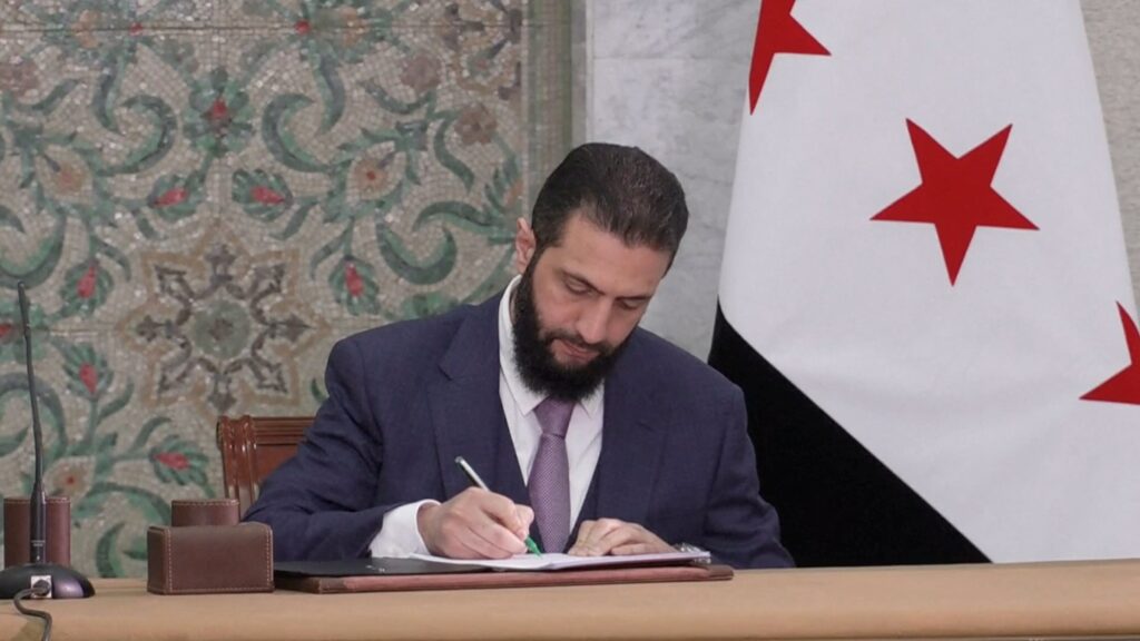 Syria's interim President Ahmed al-Sharaa signs a constitution draft, after the Syrian committee of legal experts submitted it, Damascus, Syria, March 13, 2025. (Reuters photo)