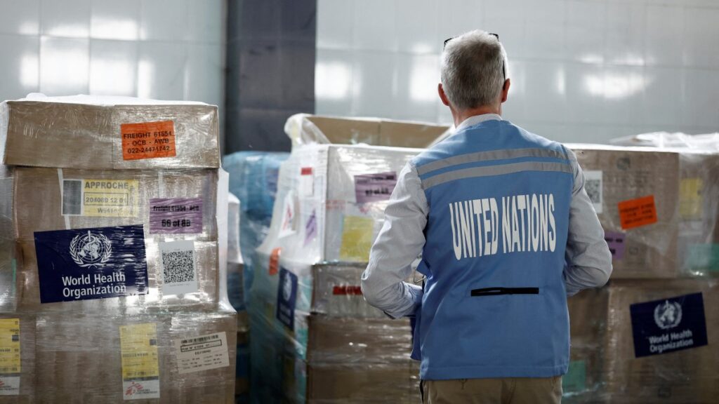 A U.N. staff member stands in front of humanitarian supplies for Gaza stored at Egyptian Red Crescent warehouses storing aid for Gaza, in the Egyptian border town of El-Arish, Egypt, April 8, 2025. (Reuters Photo)