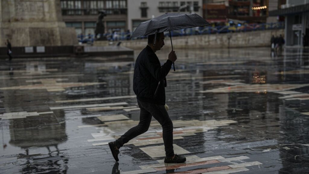 A man walks in the rain on a quiet street in Ankara, Türkiye, April 19, 2025. (AA Photo)