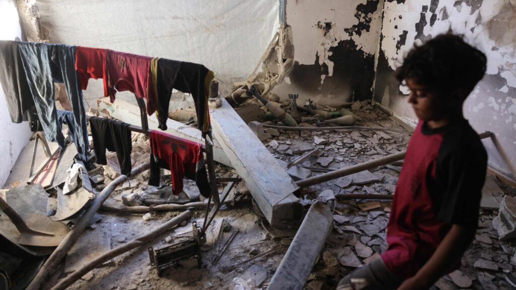 A Palestinian boy walks near unexploded ordnance, Gaza, Palestine, April 19, 2025. (AFP Photo)