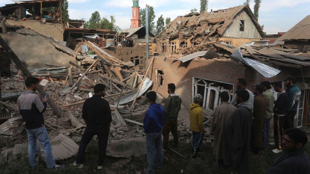 Villagers stand near the debris of demolished houses related to the family of Ahsan Ul Haq Sheikh, who officials say was involved in the Pahalgam attack, in Murran village of Pulwama, south of Srinagar, India, April 26, 2025. (EPA Photo)