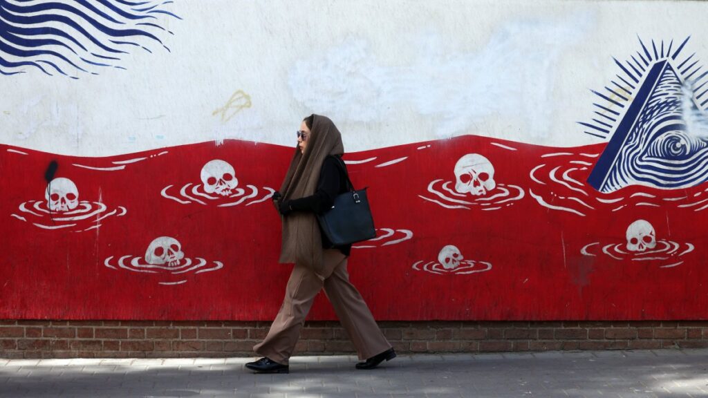 An Iranian woman walks past an anti-U.S. mural near the former U.S. embassy in Tehran, Iran, May 22, 2025. (EPA Photo)