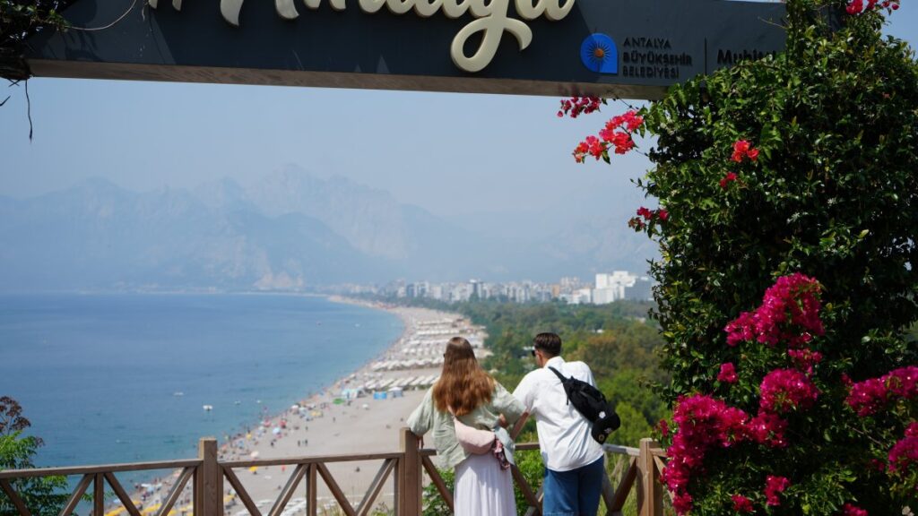 Tourists are photographed while enjoying a view of a beach in Antalya, southern Türkiye, June 6, 2025. (IHA Photo)
