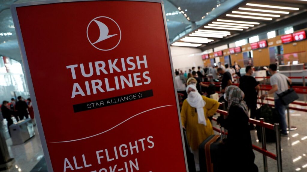 Passengers wearing protective face masks line up to check in for a flight to Washington, D.C. at Istanbul Airport, during the first day of resumed Turkish Airlines flights to the U.S. amid the COVID-19 outbreak, Istanbul, Türkiye, June 19, 2020. (Reuters Photo)