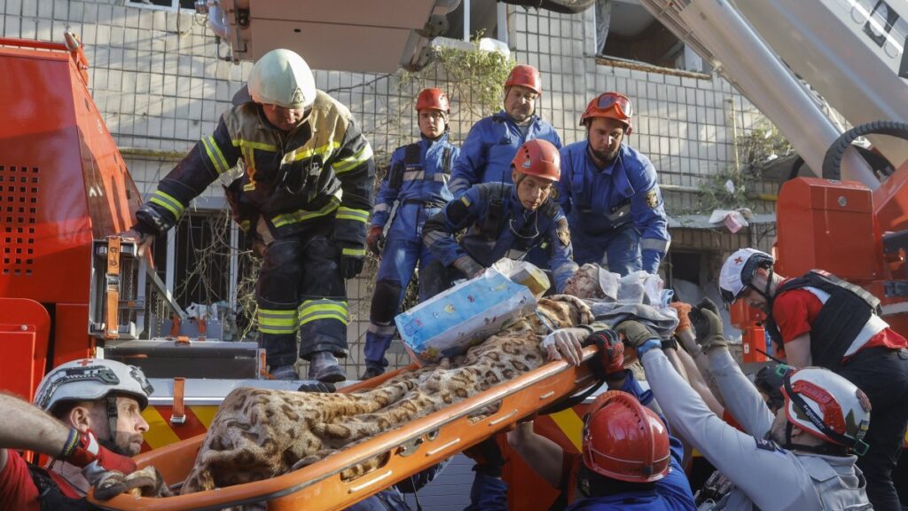 Ukrainian rescuers evacuate an injured elderly woman from the site of an airstrike on a nine-story residential building in Kyiv, Ukraine, June 17, 2025. (EPA Photo)