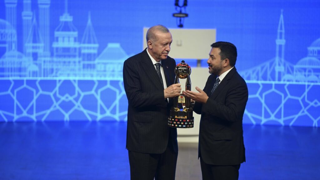 President Recep Tayyip Erdoğan receives the Grand Youth Award from ICYF Chair Taha Ayhan, Istanbul, Türkiye, June 20, 2025. (AA Photo)