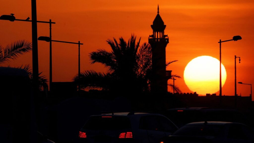 The sun sets near a mosque in Doha, Qatar, June 21, 2025. (AFP Photo)