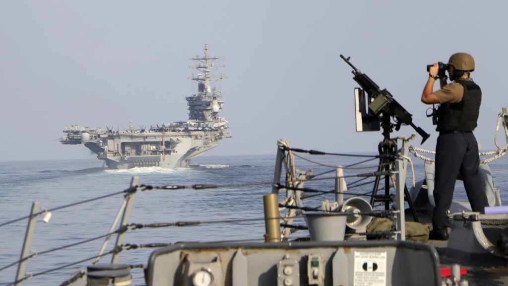 The aircraft carrier USS Dwight D. Eisenhower and other warships cross the Strait of Hormuz into the Persian Gulf Nov. 26, 2023. (AP Photo)