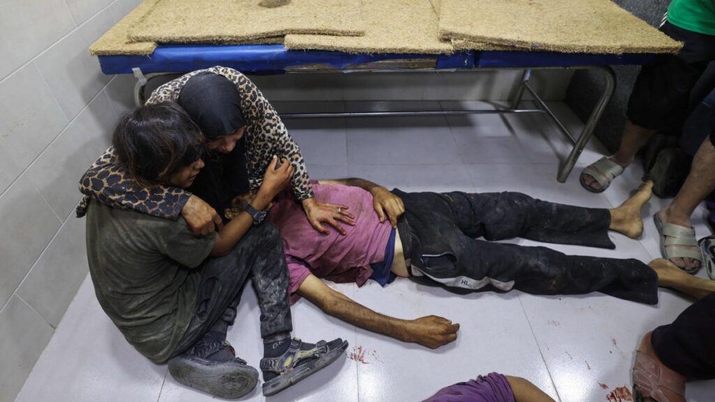Palestinians mourn by the body of a relative killed in Israeli fire at a food aid distribution point set up by the GHF, near Nuseirat, central Gaza, Palestine, June 24, 2025. (AFP Photo)