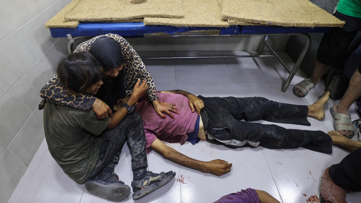 Palestinians mourn by the body of a relative killed in Israeli fire at a food aid distribution point set up by the GHF, near Nuseirat, central Gaza, Palestine, June 24, 2025. (AFP Photo)