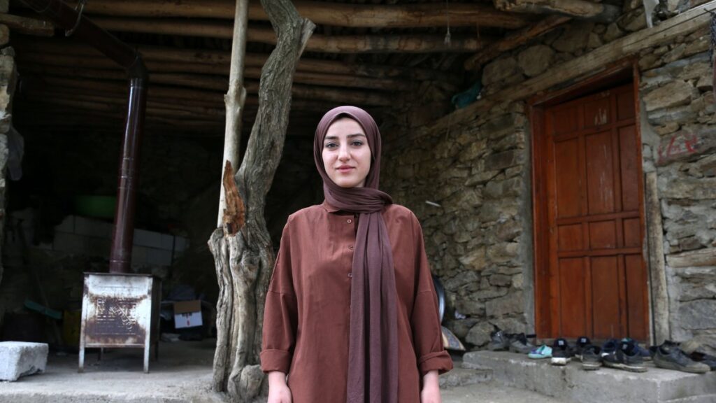 Melek Okur, 23, stands outside the village office after becoming the only female mukhtar in Hizan district of Bitlis, Türkiye, June 12, 2025. (AA Photo)