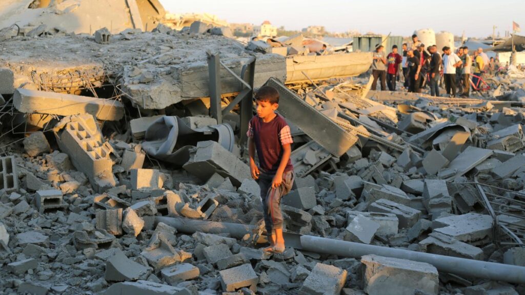 A bare-footed Palestinian boy walks on the rubble in the Al-Bureij camp in the central Gaza Strip after a house was targeted by an Israeli strike, June 27, 2025. (AFP Photo)