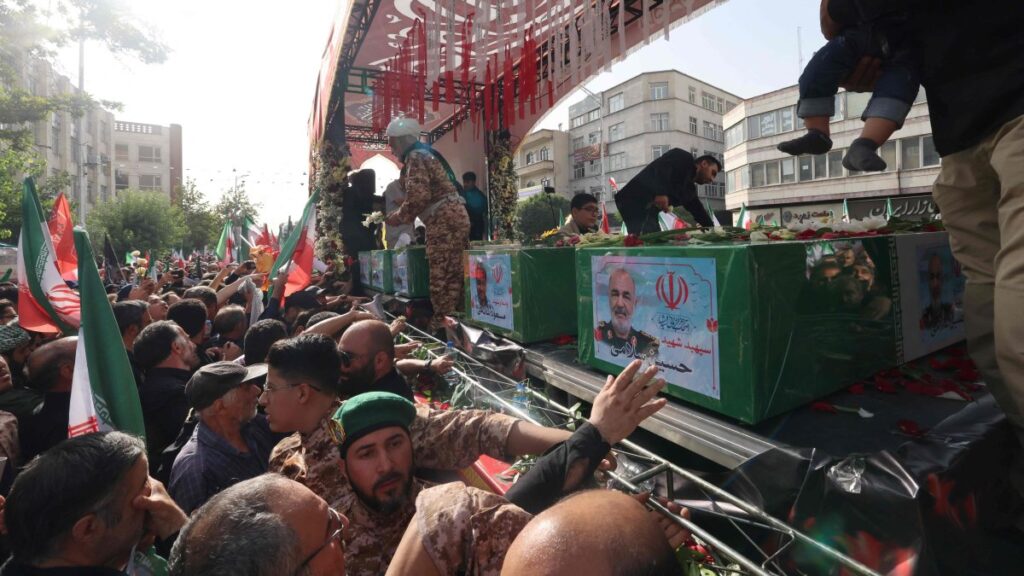 A mourner reaches out to touch the coffin of Iranian Revolutionary Guards commander Hossein Salami (C), and other military commanders killed during Israeli strikes on Iran, during their funeral procession at Enghelab (Revolution) Square in the capital Tehran, Iran, June 28, 2025. (AFP Photo)