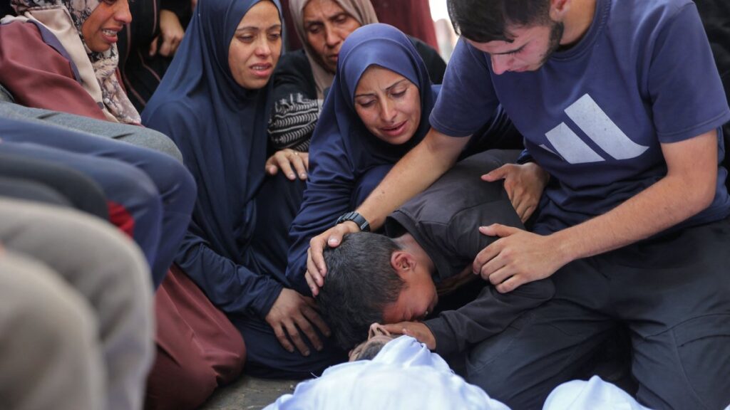 Palestinians mourn over the bodies of loved ones killed during overnight Israeli strikes, on the grounds of Al-Shifa hospital in the central Gaza Strip, June 28, 2025. (AFP Photo)