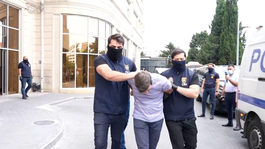 Azerbaijani security forces escort a Russian suspect detained as part of the operation, Baku, June 30, 2025. (AA Photo)