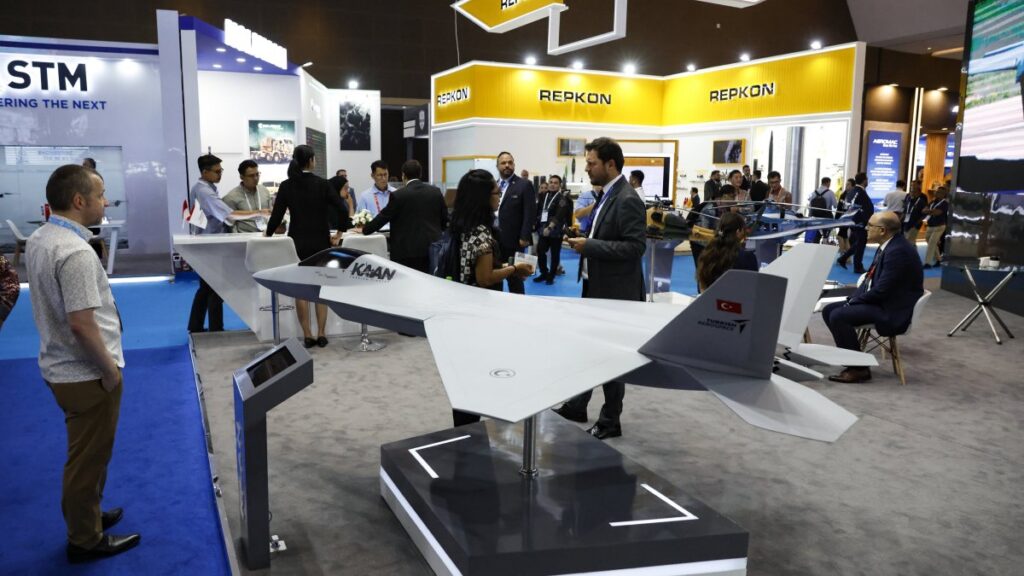 Visitors stand near miniatures of Turkish combat aircraft Kaan during the Indo Defense 2025 exhibition, Jakarta, Indonesia, June 12, 2025. (EPA Photo)