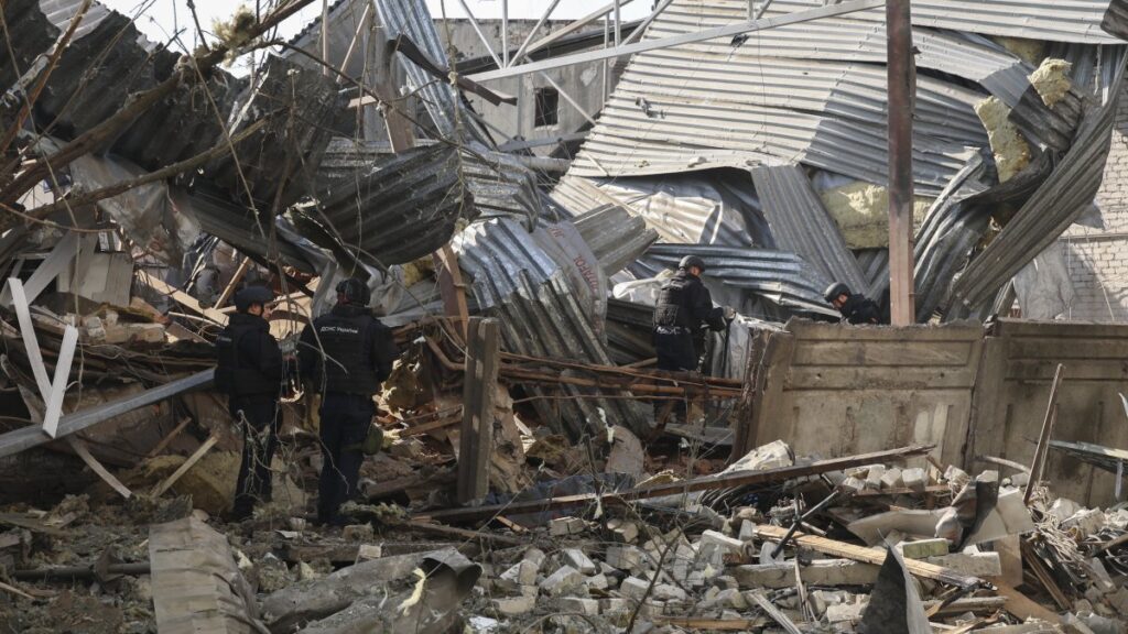 Ukrainian experts work at the site of a drone strike on a supermarket building in Kharkiv, northeastern Ukraine, July 7, 2025. (EPA Photo)
