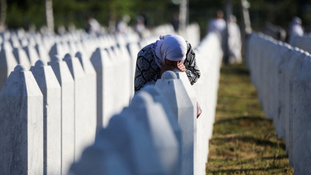 A Bosnian Muslim woman reacts as she stands amid grave stones of victims killed during the Srebrenica genocide, at the memorial cemetery in the village of Potocari, near the eastern town of Srebrenica, Bosnia-Herzegovina, July 11, 2025. (Reuters Photo)