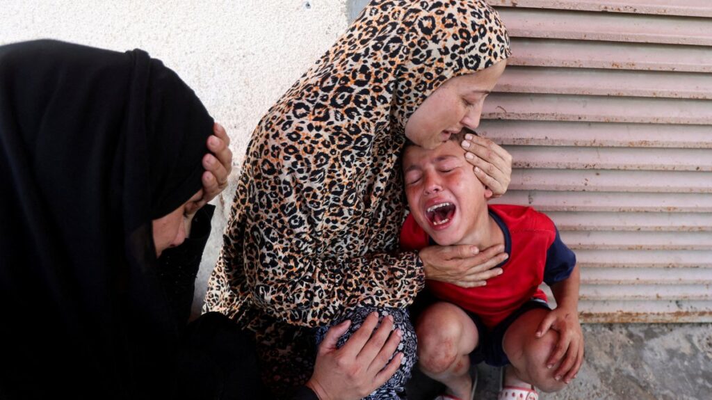 Palestinian mother Samah al-Nouri, whose daughter Sama was killed by an Israeli strike, near a medical center in Deir al-Balah, comforts her son, as casualties from the strike are brought into Al-Aqsa Martyrs Hospital, Deir al-Balah, Gaza Strip, Palestine, July 10, 2025. (Reuters Photo)