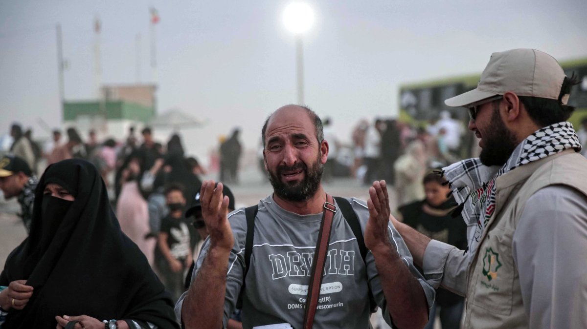 Khalil (C), an Afghan refugee, who lived in Iran for 30 years, reacts after arriving at a temporary camp at Islam Qala border, Herat province, Afghanistan, July 10, 2025. (EPA Photo)