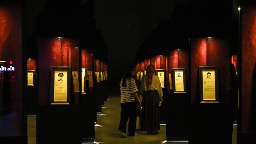 Visitors attentively view the biographies and photos of 253 martyrs at the 15 July Democracy Museum, Istanbul, Türkiye, July 10, 2025. (AA Photo)