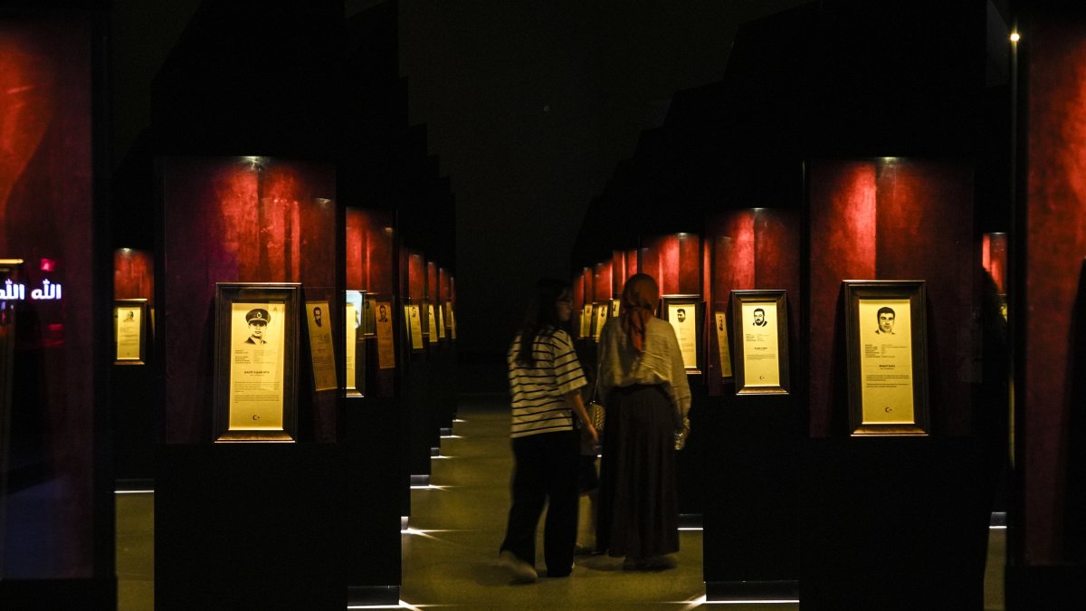 Visitors attentively view the biographies and photos of 253 martyrs at the 15 July Democracy Museum, Istanbul, Türkiye, July 10, 2025. (AA Photo)