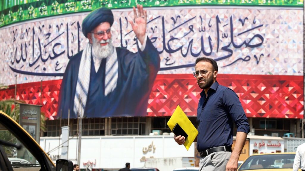 A person walks past a billboard featuring a picture of Iranian Supreme Leader Ayatollah Ali Khamenei at Valiasr Square in Tehran, Iran, July 14, 2025. (EPA Photo)