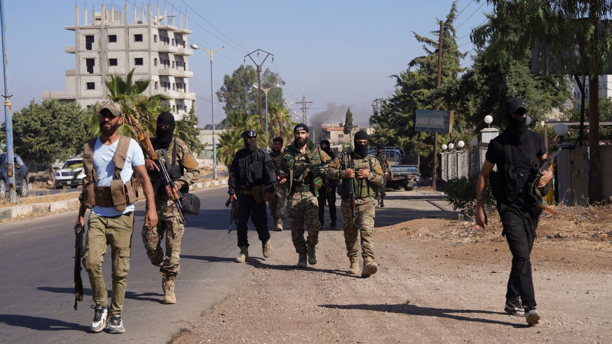 Members of Syrian security forces walk together after Syrian troops entered the predominantly Druze city of Suwayda, Syria, July 15, 2025. (Reuters Photo)