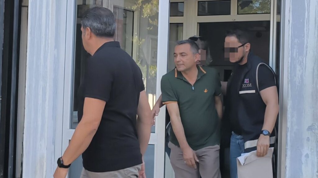 Police officers escort Manavgat Mayor Niyazi Nefi Kara after his detention, Antalya, Türkiye, July 8, 2025. (İHA Photo)