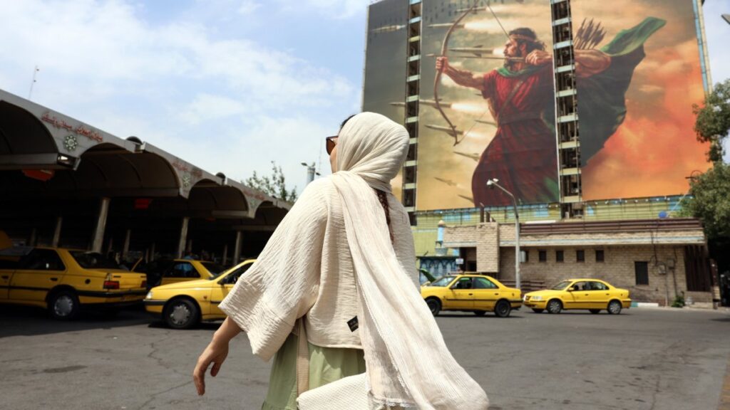 An Iranian woman walks near a large-scale mural depicting Iranian missiles in a street of Tehran, Iran, July 16, 2025. (EPA Photo)