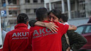 A grieving family member waits outside the Ankara Forensic Medicine Institute, embracing members of the AKUT Search and Rescue team while shedding tears, Ankara, Türkiye, July 24, 2025. (AA Photo)