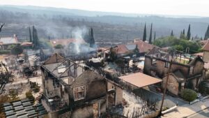 An aerial view shows burnt houses as firefighters battle a forest fire in the village of Souni, Limassol province, Greek Cypriot administration, July 24, 2025. (AFP Photo)