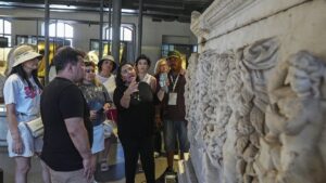 Foreign archaeologists closely examine an artifact while exploring Türkiye’s millennia-old cultural heritage in Izmir, Türkiye, July 23, 2025. (AA Photo)