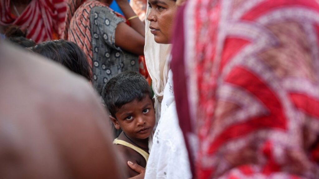 A boy stands with his mother inside a makeshift shelter camp in Goalpara district in the northeastern state of Assam, India, July 18, 2025. (Reuters Photo)