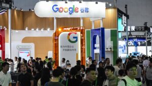 People walk past a Google stand during the World Artificial Intelligence Conference (WAIC) at the Shanghai World Expo and Convention Center, Shanghai, China, July 28, 2025. (AFP Photo)