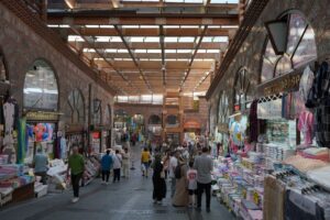 Shoppers and visitors stroll through the lively bazaar streets of Bursa, Türkiye. (Shutterstock Photo)