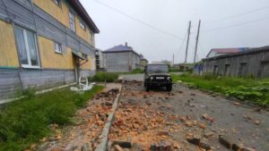 A car drives past a building damaged in the mega earthquake in Kamchatka, Far East Russia, July 30, 2025. (AA Photo)