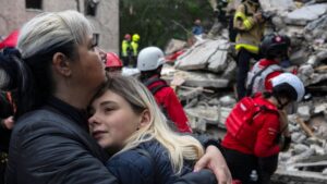 Local residents comfort each other as Ukrainian rescuers work among the rubble of a destroyed residential building following an air attack in Kyiv, Ukraine, July 31, 2025. (AFP Photo)
