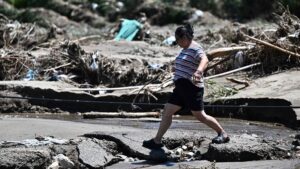 A woman walks past a flood-damaged area from heavy rains over the last few days in Huairou district, on the outskirts of Beijing, China, July 30, 2025. (AFP Photo)