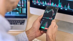 A crypto trader is seen using a smartphone in this stock photo. (Shutterstock Photo)